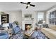 Living room with fireplace, two armchairs, and a neutral color palette at 14653 E Crestridge Dr, Centennial, CO 80015