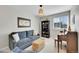 Cozy sitting room with sofa, bookcase, and piano at 14653 E Crestridge Dr, Centennial, CO 80015