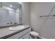 Bathroom featuring modern vanity with sink, mirror, and tiled shower at 16744 W 93Rd Pl, Arvada, CO 80007