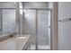 Bathroom features a glass-enclosed shower and vanity with quartz countertop at 16744 W 93Rd Pl, Arvada, CO 80007