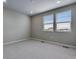 Bedroom featuring two windows, plush carpeting, and neutral paint at 16744 W 93Rd Pl, Arvada, CO 80007