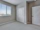 Bedroom featuring a window, closet, and neutral paint at 16744 W 93Rd Pl, Arvada, CO 80007