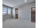 Bedroom with walk-in closet, plush carpeting, and natural light at 16744 W 93Rd Pl, Arvada, CO 80007