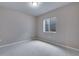 Neutral carpeted bedroom with single window at 16744 W 93Rd Pl, Arvada, CO 80007