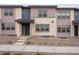 Charming townhome featuring a modern facade and inviting entrance with a covered porch and manicured landscape at 16744 W 93Rd Pl, Arvada, CO 80007