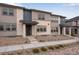 Exterior view of modern townhome with stone facade at 16744 W 93Rd Pl, Arvada, CO 80007