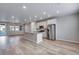 Open-concept kitchen featuring a center island with stone countertops, stainless steel appliances, and abundant natural light at 16744 W 93Rd Pl, Arvada, CO 80007