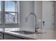 Close up of kitchen featuring a stainless steel faucet and view to outside window at 16744 W 93Rd Pl, Arvada, CO 80007