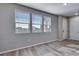 Bright living area with large windows and wood-look flooring, perfect for relaxing or entertaining guests at 16744 W 93Rd Pl, Arvada, CO 80007