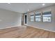 Bright living room with hardwood floors, neutral paint, and view of the neighborhood at 16744 W 93Rd Pl, Arvada, CO 80007