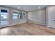 Spacious living room with hardwood floors, natural light, and access to outdoor deck at 16744 W 93Rd Pl, Arvada, CO 80007