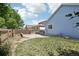 A backyard view features the privacy fence, light blue home exterior, manicured lawn, and a stone patio at 13959 E 106Th Ave, Commerce City, CO 80022