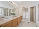 Spacious bathroom features dual sinks, a large mirror and tile flooring at 13959 E 106Th Ave, Commerce City, CO 80022