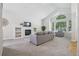 Spacious living room with vaulted ceilings, fireplace, and large windows offering natural light at 13959 E 106Th Ave, Commerce City, CO 80022