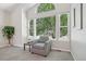 Inviting living room area with an accent chair and lots of natural light at 13959 E 106Th Ave, Commerce City, CO 80022