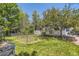Beautifully landscaped backyard with garden beds and a spacious deck at 9545 Grand Cypress Cv, Lone Tree, CO 80124