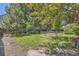 Lush backyard with mature trees, garden beds, and a tranquil setting at 9545 Grand Cypress Cv, Lone Tree, CO 80124
