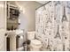 Cozy bathroom with toilet, sink, and a Paris-themed shower curtain at 9545 Grand Cypress Cv, Lone Tree, CO 80124