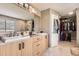 Bright bathroom with double vanity, walk-in closet, and modern finishes at 9545 Grand Cypress Cv, Lone Tree, CO 80124