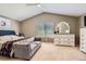 Bright primary bedroom featuring a ceiling fan, dresser, and comfortable seating area at 9545 Grand Cypress Cv, Lone Tree, CO 80124