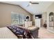 Bright primary bedroom featuring a ceiling fan, dresser, guitar and comfortable seating area at 9545 Grand Cypress Cv, Lone Tree, CO 80124