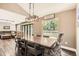 Elegant dining room with a large table, modern lighting, and patio access at 9545 Grand Cypress Cv, Lone Tree, CO 80124