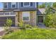 Attractive home featuring a stone facade, well-kept lawn, and a welcoming entrance at 9545 Grand Cypress Cv, Lone Tree, CO 80124