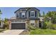 Beautiful two-story home featuring stone accents, a two-car garage, and manicured landscaping at 9545 Grand Cypress Cv, Lone Tree, CO 80124