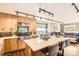 Bright kitchen with island seating, modern lighting and stone countertops, leading to living space at 9545 Grand Cypress Cv, Lone Tree, CO 80124