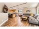 Open concept living space with hardwood floors, kitchen island, and comfortable seating at 9545 Grand Cypress Cv, Lone Tree, CO 80124
