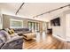 Spacious living room featuring hardwood floors, comfortable seating, and sliding glass doors to the patio at 9545 Grand Cypress Cv, Lone Tree, CO 80124