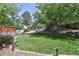 Spacious backyard with lush lawn and mature trees at 722 S Eagle St, Aurora, CO 80012