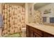 Bathroom with golf-themed shower curtain and wood vanity at 722 S Eagle St, Aurora, CO 80012