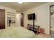 Cozy bedroom with built-in shelving and a flat-screen TV at 722 S Eagle St, Aurora, CO 80012