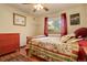 Bright bedroom with red dresser and floral bedding at 722 S Eagle St, Aurora, CO 80012