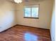 Simple bedroom with wood-look flooring and window at 722 S Eagle St, Aurora, CO 80012