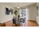 Charming dining area with hardwood floors and sliding door access to a deck at 722 S Eagle St, Aurora, CO 80012