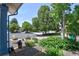 Landscaped front yard with mature trees and colorful flowers at 722 S Eagle St, Aurora, CO 80012