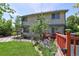 Rear view of two-story house with yard and deck at 722 S Eagle St, Aurora, CO 80012