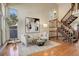 Bright living room with hardwood floors, a staircase, and comfortable seating at 722 S Eagle St, Aurora, CO 80012