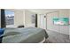 Bedroom featuring plush carpeting, double closets, and a mounted flatscreen TV at 12125 Bannock St # C, Westminster, CO 80234