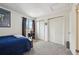 Carpeted bedroom with double closets, a window, and comfortable furnishings at 12125 Bannock St # C, Westminster, CO 80234