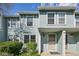 Inviting light-blue townhome featuring a secure entry and well-maintained landscaping at 12125 Bannock St # C, Westminster, CO 80234