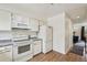 Clean kitchen with white appliances, cabinetry, and granite countertops at 12125 Bannock St # C, Westminster, CO 80234