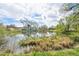 Reflective pond enhances the community with nature's beauty, surrounded by lush greenery and scattered trees at 12125 Bannock St # C, Westminster, CO 80234