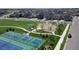 Aerial view of neighborhood park with playgrounds, pickleball and tennis courts, and a gazebo at 148 Baler Ct, Brighton, CO 80601