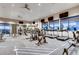 Community gym with weights, treadmills, stationary bikes, and multiple televisions at 148 Baler Ct, Brighton, CO 80601
