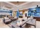 Community lounge featuring multiple seating areas, kitchen, modern lighting, and stylish décor at 148 Baler Ct, Brighton, CO 80601