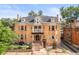 Stately brick home featuring a welcoming front porch and manicured landscaping at 2124 E 17Th Ave # 4, Denver, CO 80206