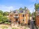 Elegant home with brick facade, balconies, manicured landscaping, and a welcoming entrance at 2124 E 17Th Ave # 4, Denver, CO 80206